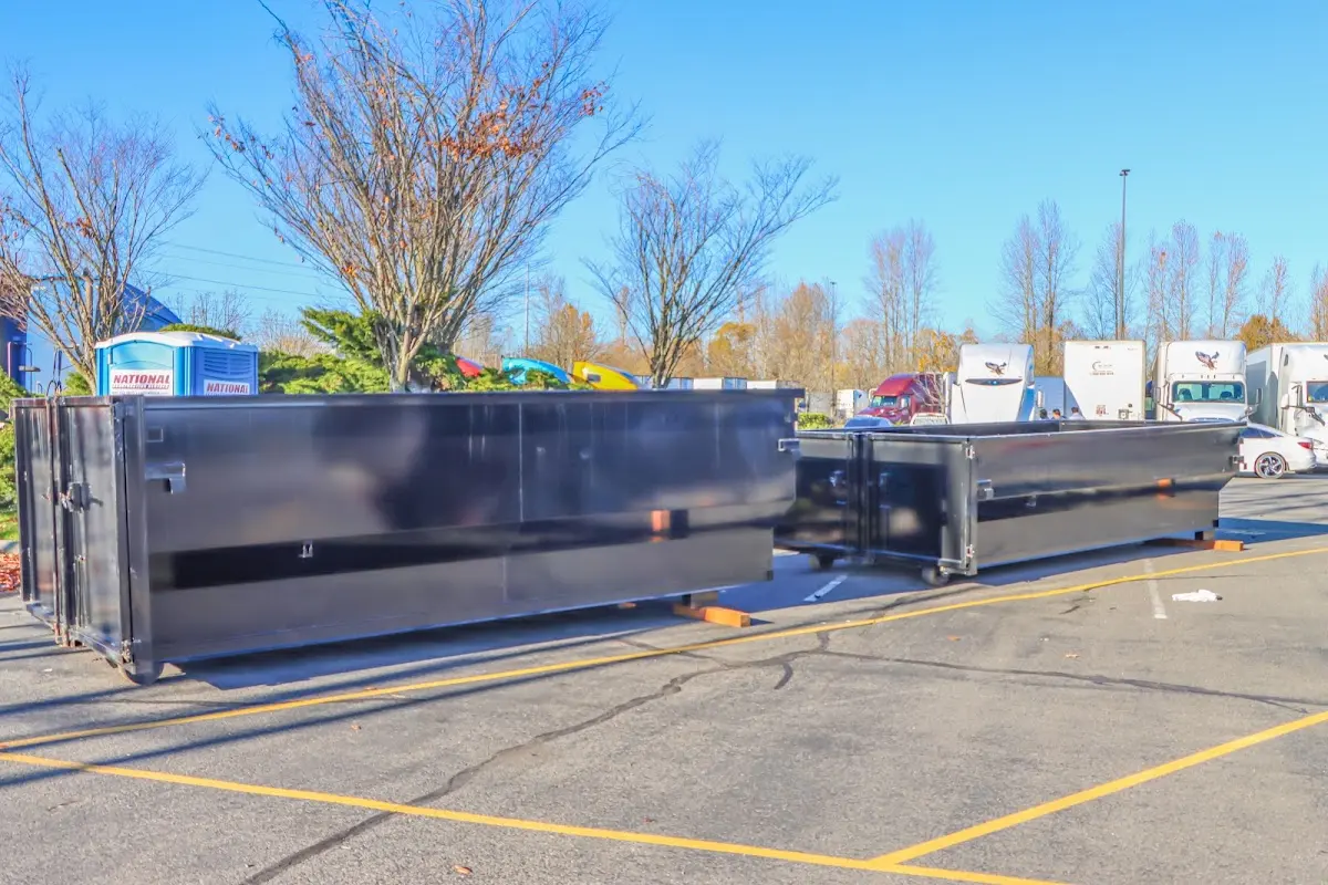 Professional dumpster rental service with roll-off container on residential driveway in Olyphant
